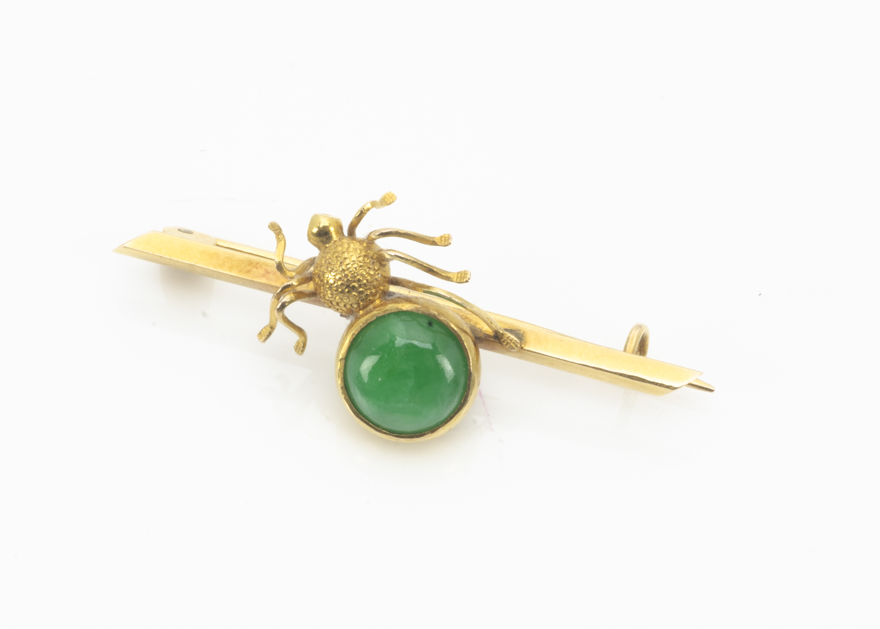 A Chinese 18ct gold and jade spider bar brooch, the central gold spider with jade cabochon