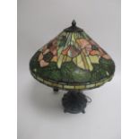 A Tiffany style lamp, decorated in poppies, on a cast metal base, height 63cm