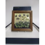 A contemporary Moorcroft pottery framed plaque, in the 'Hepatica' pattern, signed by the designer