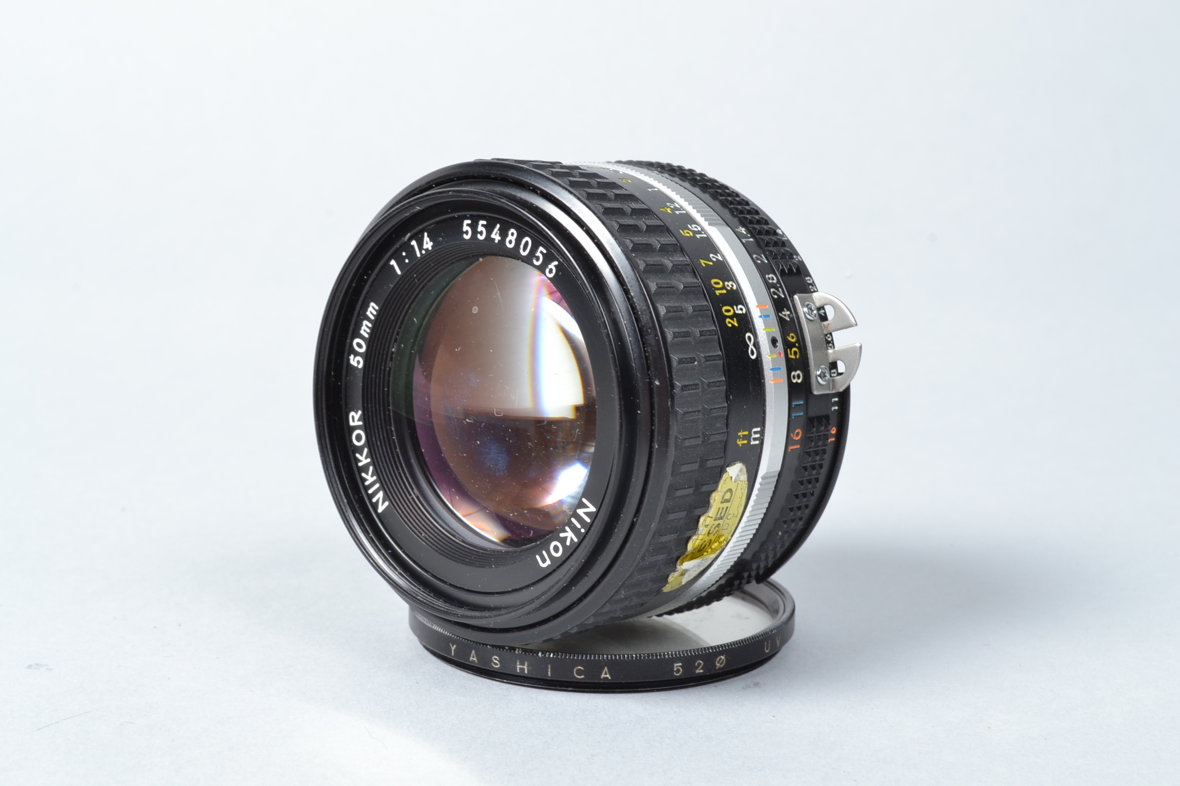 A Nikon Nikkor 50mm f/1.4 AIS Lens, serial no 5548056, barrel G, elements G, issues with and oil