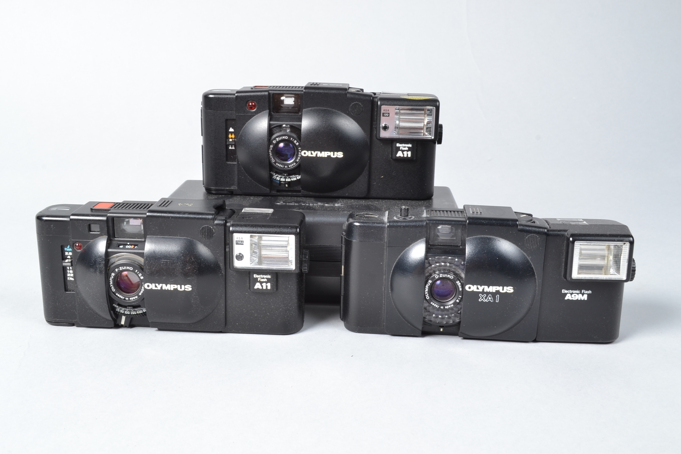 Olympus XA Compact Cameras, an Olympus XA, with A11 flash, XA-1, with A9M flash, XA-2, with A11