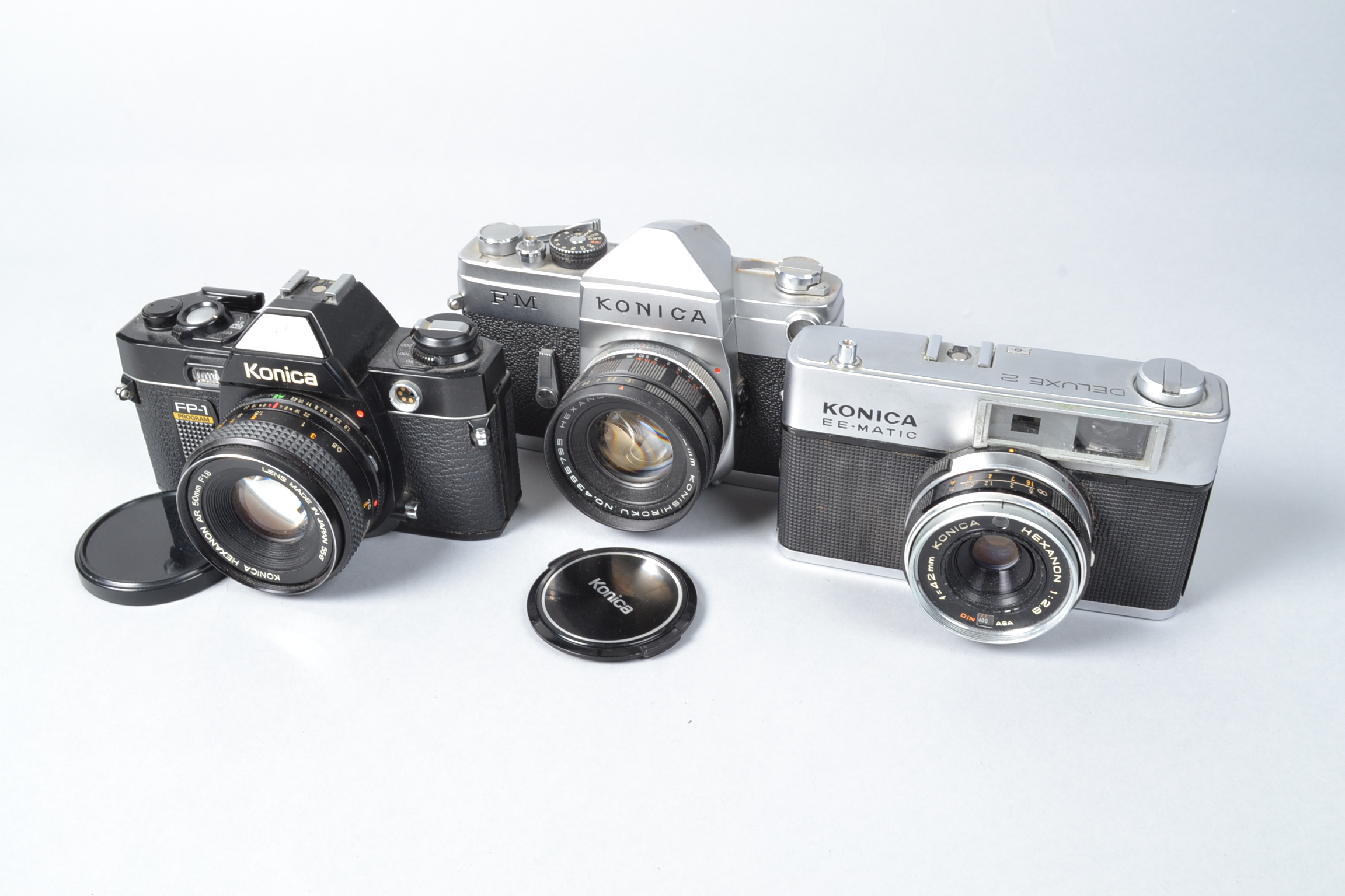 Three Konica Cameras a Konica FP-1, with 50mm f/1.8 lens, FM, with 52mm f/1.8 lens and a EE-Matic