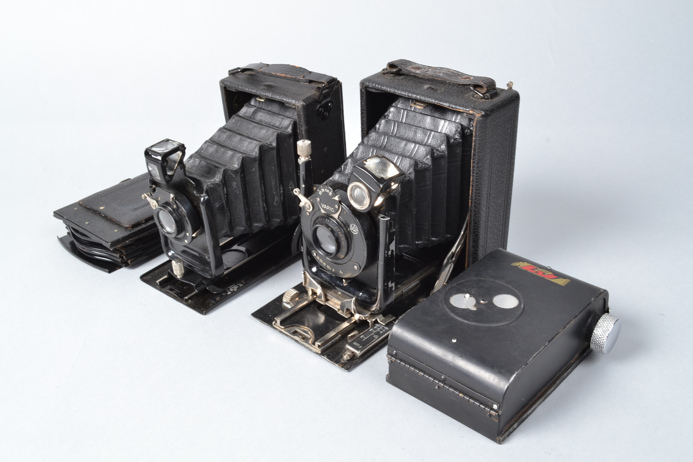 Two Folding Plate Cameras, an Erneman Heag, a Glunz model 40, a roll film back, five film slides, in