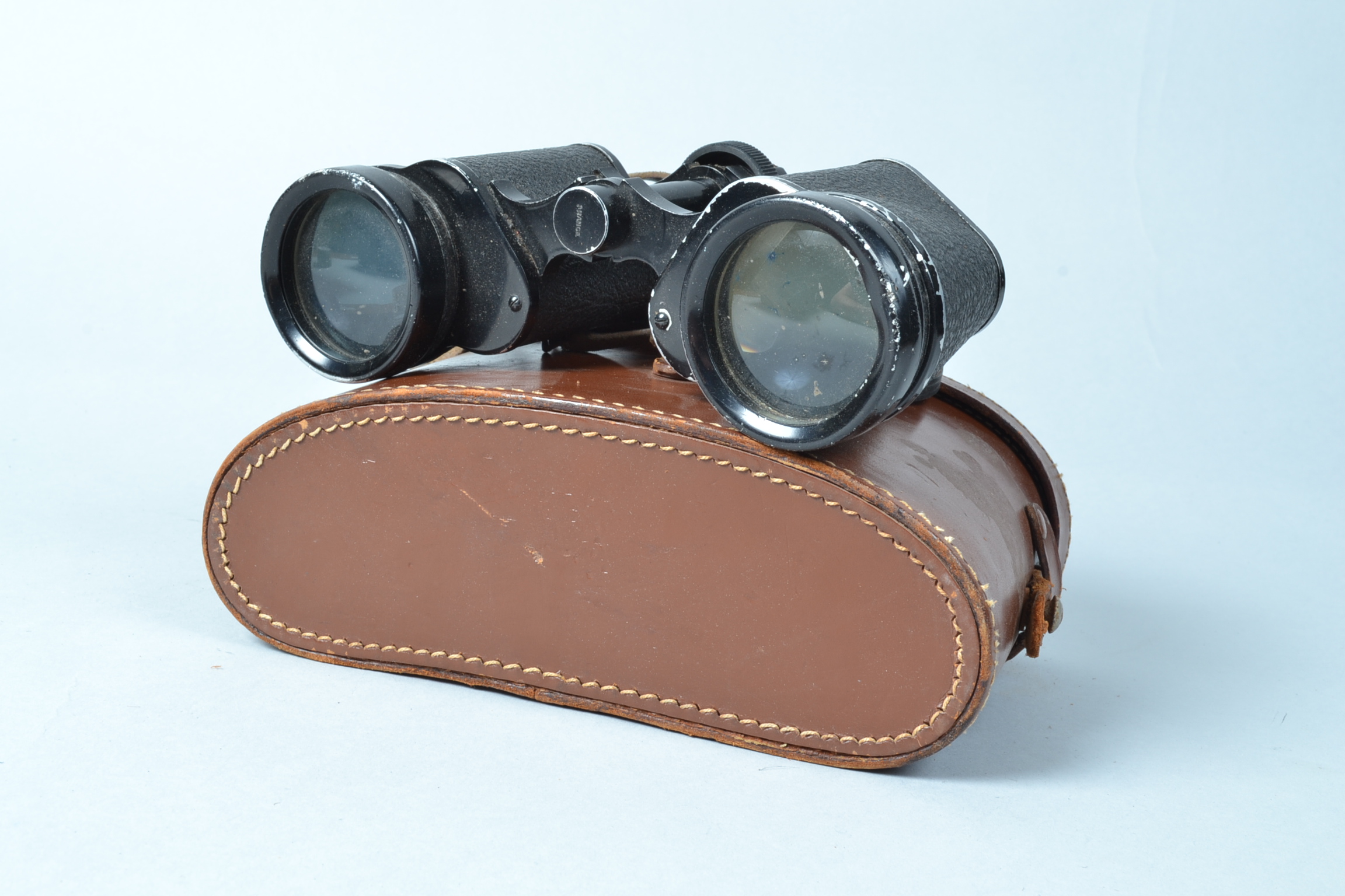 A Pair of Newbold & Bulford Binoculars, engraved Britannia Coated Lenses, body F-G, ding to one rim,