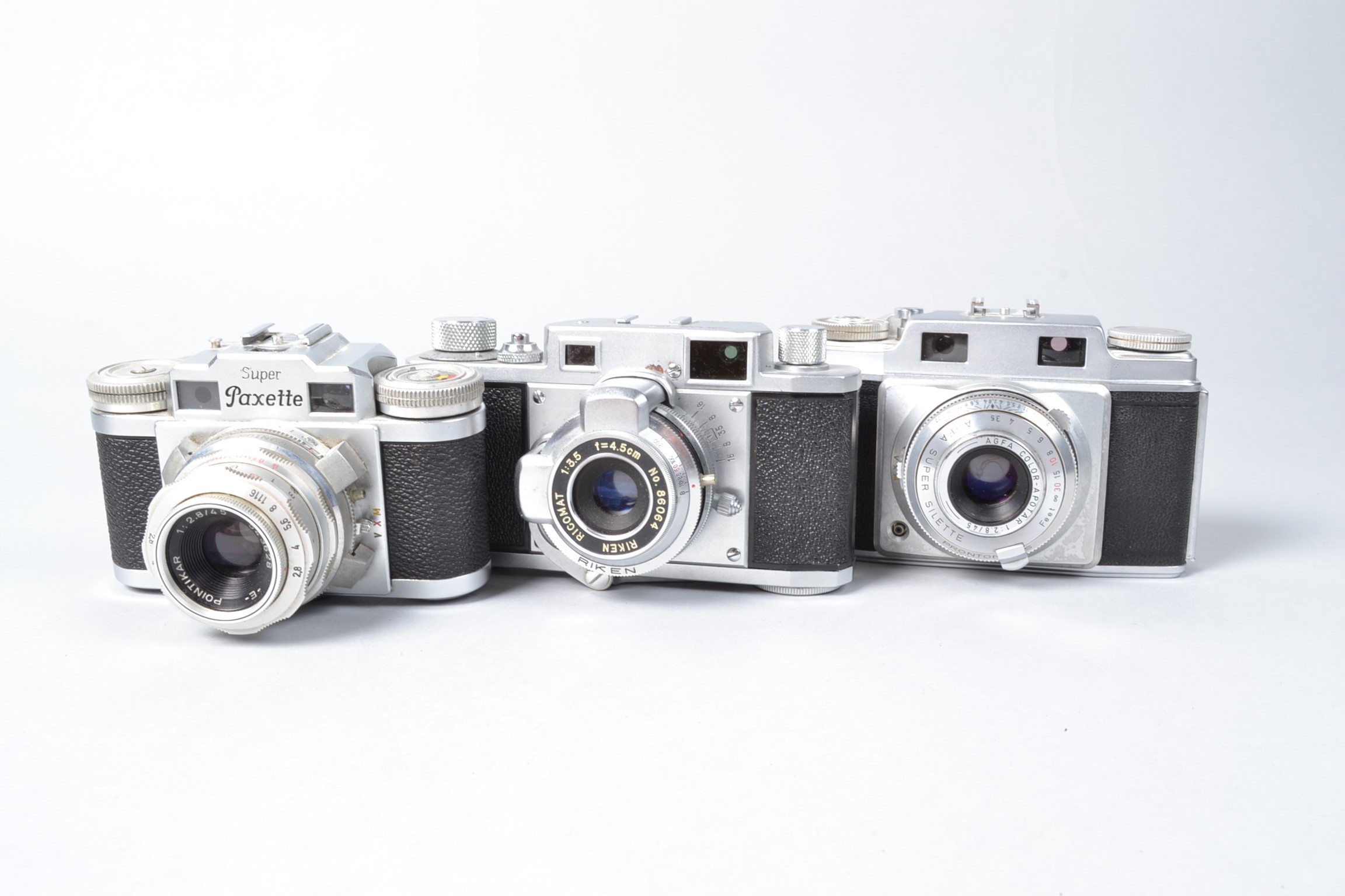 Three Rangefinder Cameras, a Braun Super Paxette, with 45mm f/2.8 lens, Ricoh 35, with 4.5cm f/3.5