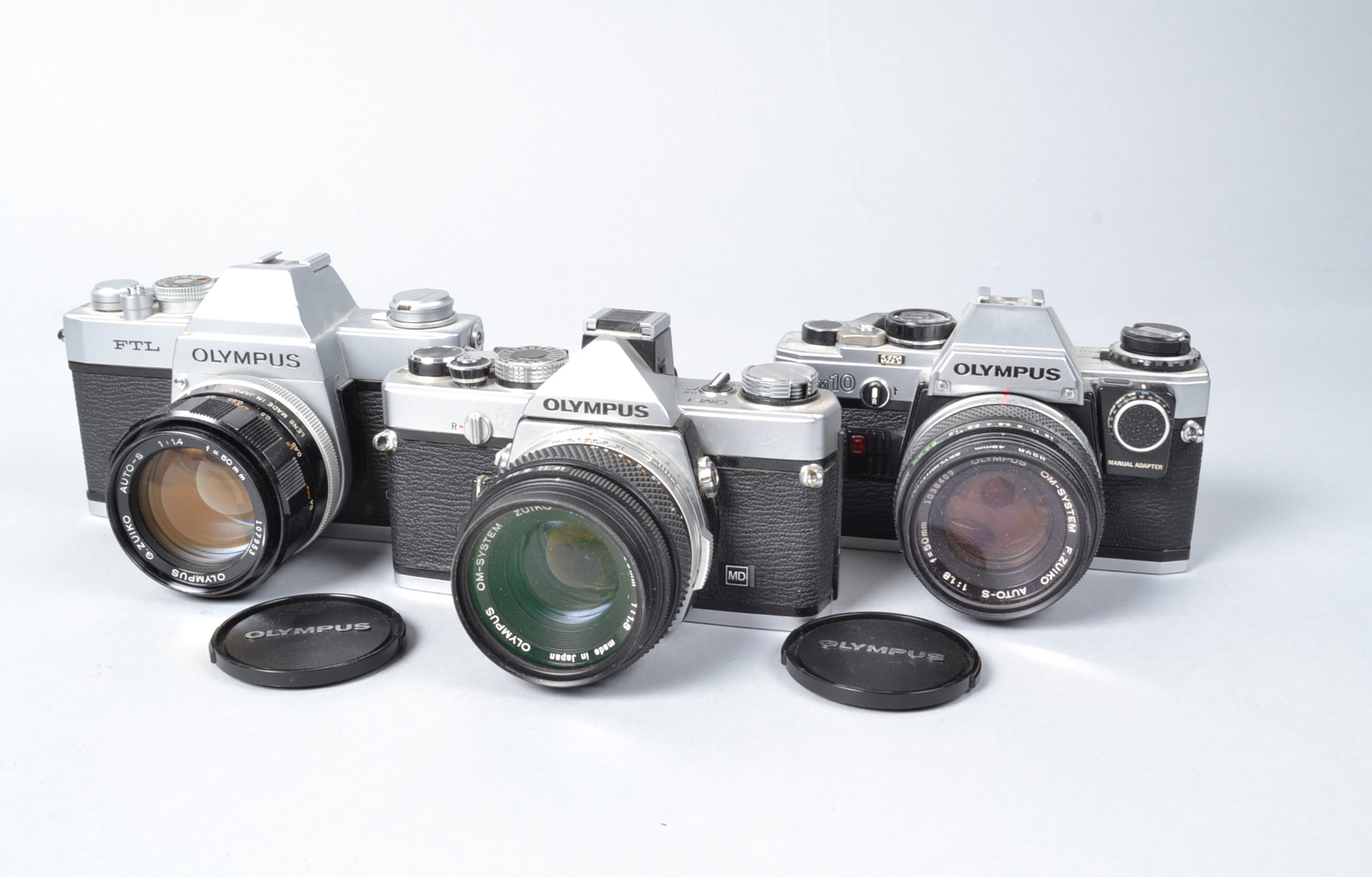 Three Olympus SLR Cameras, an Olympus FTL, with G Zuiko Auto-S 50mm f/1.4 lens, OM-1, with Zuiko