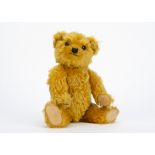 A fine Chiltern 1930s Hugmee teddy bear, with bright golden mohair, orange and black glass eyes,