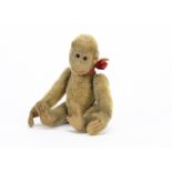 A small early jointed monkey 1910-20s, with short blonde mohair, black glass eyes, felt face,