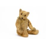 An early Farnell teddy bear, with apricot mohair, black boot button eyes, black stitched nose,