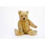 A Chiltern 1930s Hugmee teddy bear, with golden mohair, clear and black glass eyes with remains of