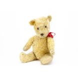 A 1930s Chiltern-type teddy bear, with golden mohair, clear and black glass eyes with remains of