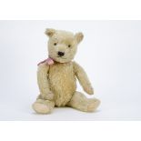 A 1930s Chiltern-type teddy bear, with light golden mohair, clear and black glass eyes, pronounced