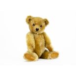 A fine Chiltern 1930s Hugmee teddy bear, with blonde mohair, clear and black glass eyes with remains