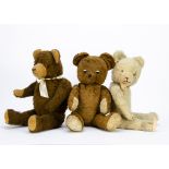 Three post-war Continental teddy bears: one with brown cotton plush and black and white metal button