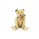 A 1920s Bing teddy bear, with golden mohair, clear and black glass eyes with brown backs, pronounced