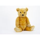 A fine Chiltern 1930s Hugmee teddy bear, with bright golden mohair, orange and black glass eyes,