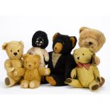 Five post-war British teddy bears: a ginger mohair example with orange plastic eyes, swivel head and