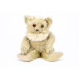 A Moritz Pappe pale yellow musical teddy bear 1920s, with long mohair, bright orange and black glass