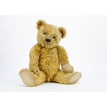A Chiltern 1930s Hugmee teddy bear, with golden mohair, clear and black glass eyes with remains of