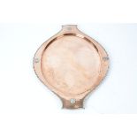 An early 20th Century twin handled oval hammered copper and white metal tray, with impressed '