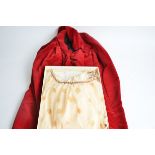 A vintage red femme fatale style satin cape, with original label Estrava of London, together with