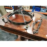 An iron ceiling light with four branches, approximate length 64cm, together with a candle holder,