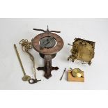A Black Forest style clock movement, length 37cm, together with another brass clock movement (2)
