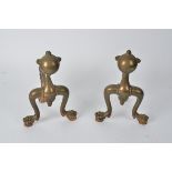 A pair of late 19th Century brass and copper andirons, in the form of the paws of a mythical