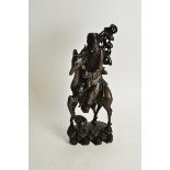 A Chinese root carving of an Immortal riding a stag, probably Shoulao clasping a peach and staff,