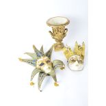 A pair of Italian Venetian style masks, together with an ornate gilt vase in the campagna shape,