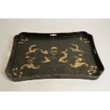 A Chinese lacquer tray, with confronting dragons chasing the flaming pearl, 58cm x 37cm a/f