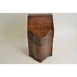 A 19th Century mahogany serpentine knife box, the hinged lid opening to reveal an empty compartment,