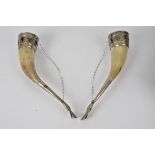 A pair of 20th Century ceremonial ox horn drinking cups, with silver plated mounts, and supported on