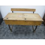 A vintage oak double school desk, lift up desk lids, inkwell holes and pen slots, integrated folding