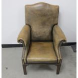 A Georgian style arm chair, mushroom coloured leather upholstery with brass studding, raised