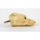 A 19th Century European ivory carving, taking the form of a dog's head, with beaded glass eyes,