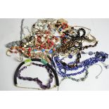 A quantity of costume jewellery, to include a thick beadwork necklace with black and green beads,