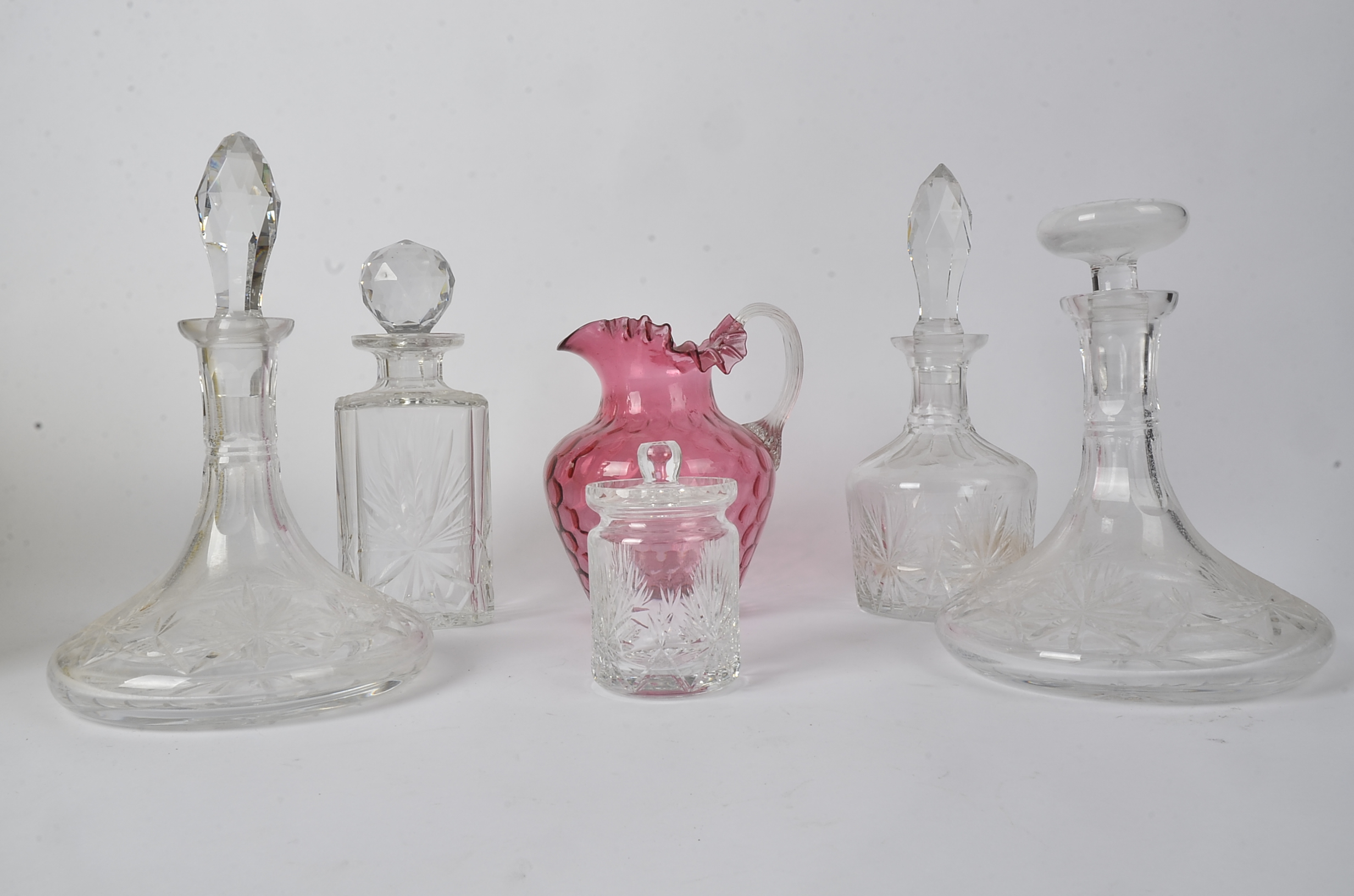Four glass decanters, together with a cranberry glass jug and lidded pot (6)