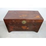 A Oriental hardwood trunk, top and front having a moulded landscape design, inset handles to