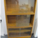 A mid-century Simplex light oak five tier sectional bookcase, four larger section having one a