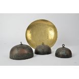 A graduated trio of Asian metalwork bells, with key fret lower borders and floral decoration,