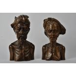 A pair of Indonesian hardwood busts, one male and one female, marked to the base "Njana Tilem