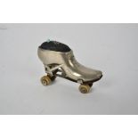 An Edwardian novelty pin cushion in the form of a roller skate, with early rubberised wheels, length