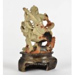 A 19th Century Chinese soapstone carved figure, modelled as a seated warrior upon a mythical