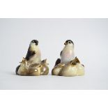 A pair of Royal Doulton figures of birds surrounded by their young, with open beaks, HN214, the