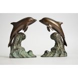 A pair of bronze dolphins, each riding the crest of a wave, height 15.5 cm