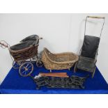 A 19th century dolls push chair, sold together with a wicker dolls basket, dolls pram and a