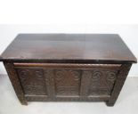 A carved oak panelled coffer, of 18th century origin, candle box to the interior, 127cm x 57cm x