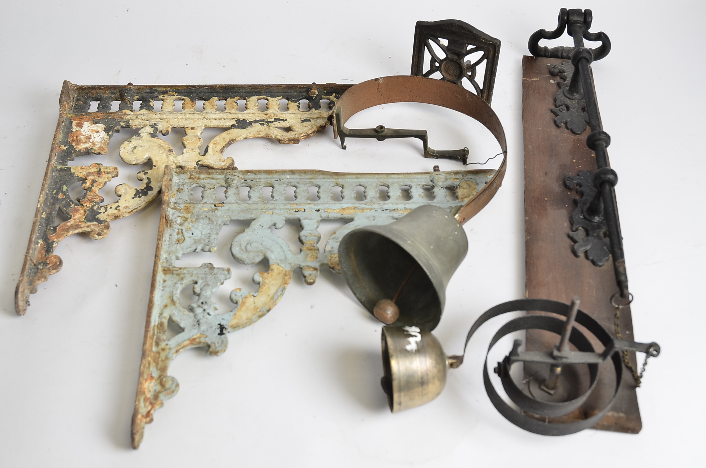 A Victorian shop's door bell and bell pull, together with a pair of cast iron wall brackets and