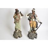 A pair of Goldscheider style painted terracotta statues of Ottoman type figures, one female, one